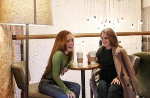 Diverse friends resting in cafe photo