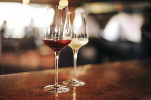 Wine bottle and glasses on the table, against the background of wine dinner. photo