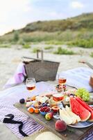 Picnic on the beach at sunset in the style of boho photo