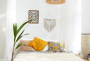 White and beige bedroom in boho style with macrame photo