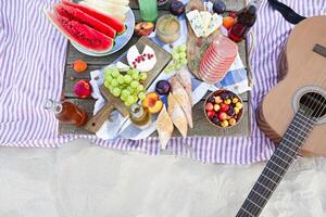 Picnic on the beach at sunset in the style of boho photo