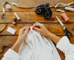 Female dressmaker creating clothes in workshop photo