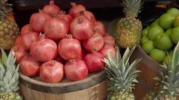 A vibrant display of colorful assorted fresh fruits at a bustling market stand awaits you video