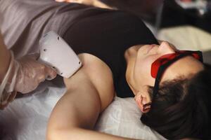 Woman on procedure of laser epilation photo