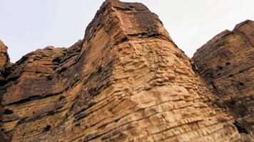 View of red rock mountain, national park. Drone flying through the wilderness. Landscape of arid mountains, racing drone piloting down a cliff video