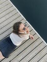 Anonymous woman playing with water on pier photo