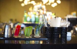 Bar counter with bottles in blurred background photo