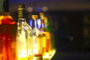 Bar counter with bottles in blurred background photo