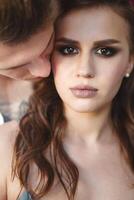 Tattoed stylish guy hugging his beautiful girlfriend photo