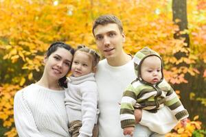 Smiling family with two children outdoors photo