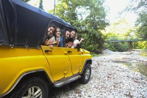 Happy smiling family with kids in the car with mountain river background photo