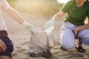 Volunteers collect trash, plastic garbage bottles on the beach. Ecology, environment, pollution and ecological problems concept photo