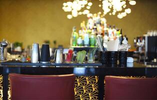 Bar counter with bottles in blurred background photo
