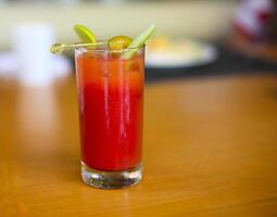 Bloody mary cocktail on a busy bar top photo