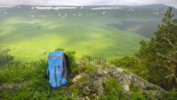 Backpack in the mountains with views of the mountains on a sunny day photo