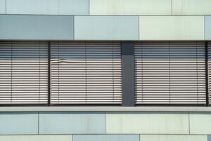 office building facade with windows and blinds photo