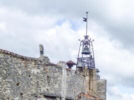 open church tower with bell in provence,france photo