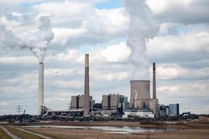 large power station with chimneys and cooling tower photo