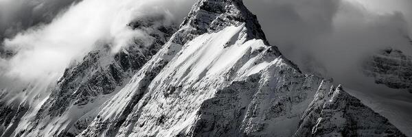 mountain peak looks out of the clouds photo