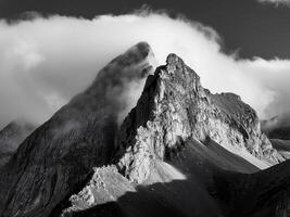 mountain peak looks out of the clouds photo