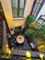 Cozy Courtyard Cafe with String Lights and Greenery photo