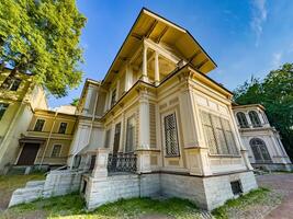 A beautifully preserved historic mansion in St. Petersburg, showcasing intricate architectural details and set against a backdrop of lush greenery. Perfect for themes of heritage, architecture, and cultural history photo