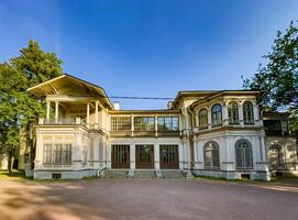 A beautifully preserved historic mansion in St. Petersburg, showcasing intricate architectural details and set against a backdrop of lush greenery. Perfect for themes of heritage, architecture, and cultural history photo
