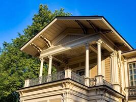 A beautifully preserved historic mansion in St. Petersburg, showcasing intricate architectural details and set against a backdrop of lush greenery. Perfect for themes of heritage, architecture, and cultural history photo
