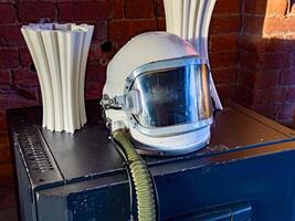 A close-up shot of a vintage space helmet placed on a display table, capturing the nostalgic essence of space exploration. Ideal for space history and science-themed projects. photo