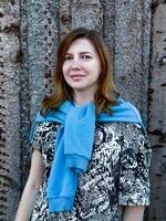 A close-up portrait of a young woman enjoying the natural beauty of a forest setting. Ideal for themes of mindfulness, serenity, and connection with nature photo