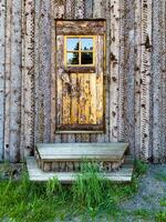 A charming rustic cabin nestled in the heart of a forest, showcasing traditional wooden architecture. Ideal for themes of countryside living, nature retreats, and rustic charm photo