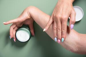 woman applies a jar of cleansing skin scrub to her hand,cosmetics daily rituals, High quality photo