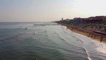 Aerial view of Jesolo beach, near Venice in Italy, coast with sunset. Adriatic Sea in the Mediterranean with beaches full of tourists on holiday and traveling in summer. Top view of umbrellas, hotels. video