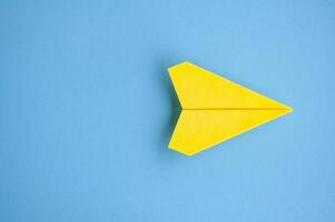 Top view of yellow paper airplane with customizable space for text or ideas photo