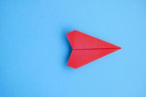 Top view of red paper airplane with customizable space for text or ideas photo