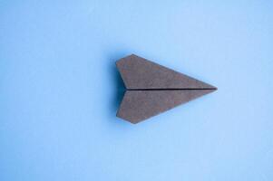 Top view of black paper airplane with customizable space for text or ideas photo