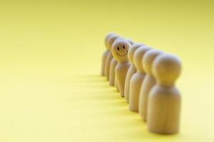 A wooden figure looking with happy face. Representing satisfaction or happy with something photo