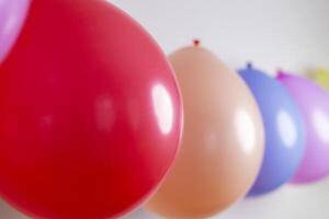 Multicolored balloons in a row with selective focus on a red balloon photo