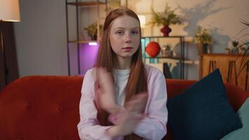 Angry girl say No hold palm folded crossed hands, warning of finish, Stop gesture, declining talk video