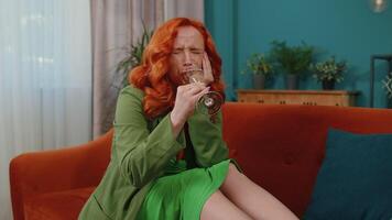 Sad depressed young redhead girl suffers from unrequited love, drinking champagne, problem, bad news video