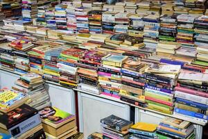 New Delhi, India, February 17 2024 - Variety of Books on shelf inside a book-stall at Delhi International Book Fair, Selection of books on display in Annual Book Fair at Bharat Mandapam complex photo