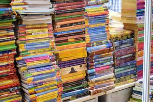 New Delhi, India, February 17 2024 - Variety of Books on shelf inside a book-stall at Delhi International Book Fair, Selection of books on display in Annual Book Fair at Bharat Mandapam complex photo