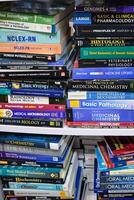 New Delhi, India, February 17 2024 - Variety of Books on shelf inside a book-stall at Delhi International Book Fair, Selection of books on display in Annual Book Fair at Bharat Mandapam complex photo