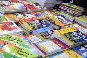 New Delhi, India, February 17 2024 - Variety of Books on shelf inside a book-stall at Delhi International Book Fair, Selection of books on display in Annual Book Fair at Bharat Mandapam complex photo