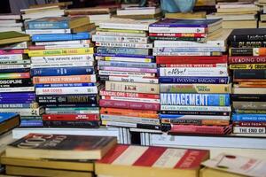New Delhi, India, February 17 2024 - Variety of Books on shelf inside a book-stall at Delhi International Book Fair, Selection of books on display in Annual Book Fair at Bharat Mandapam complex photo