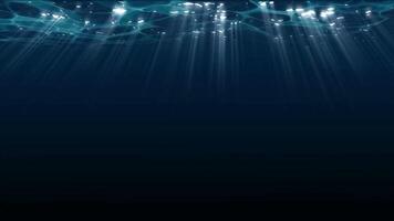 View of sunlight from a blue abyss in slow motion. Light filters down through the blue water. Underwater sun rays penetrate the depths of the ocean. Sunlight shines under deep water, creating ripples video