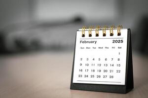 Calendar page February of the year 2025 white color in meeting room in office. with copy space and business design. concept of planning and setting new strategic goals. photo