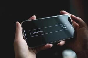 Businessman hand typing on smartphone with bar tool to search for information Using for your website, the discovery of information, search engine optimization photo