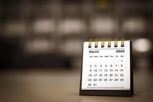 Calendar page March of the year 2025 white color in meeting room in office. with copy space and business design. concept of planning and setting new strategic goals. photo