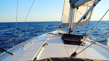Yacht sailing in an open sea. Close-up view of the deck, mast and sails. Yachting concept. High quality 4k footage video